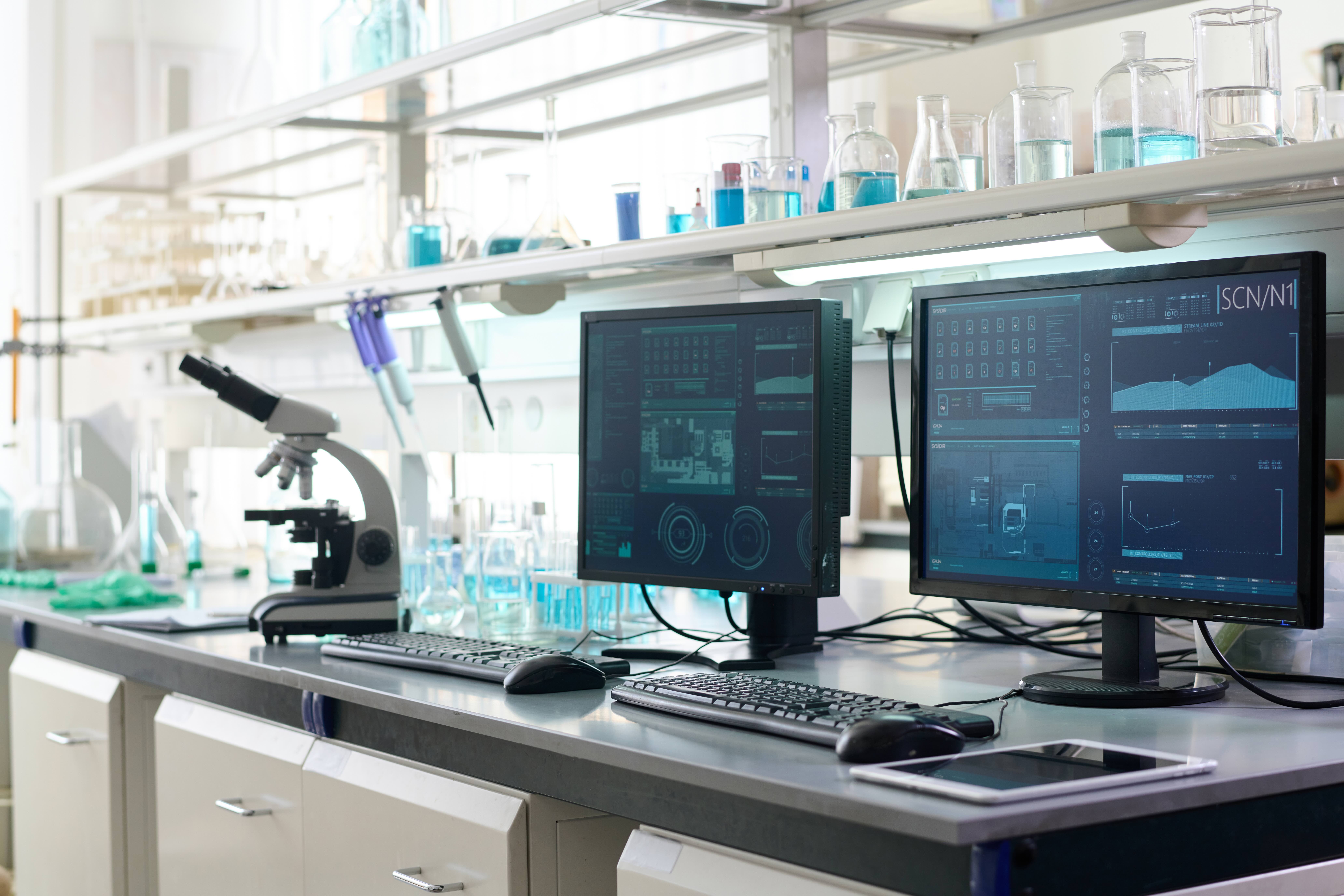 A modern laboratory office interior with computers on desks, representing a discoverable, unified directory of university research resources managed by QReserve to eliminate departmental silos and prevent duplicate equipment purchases.