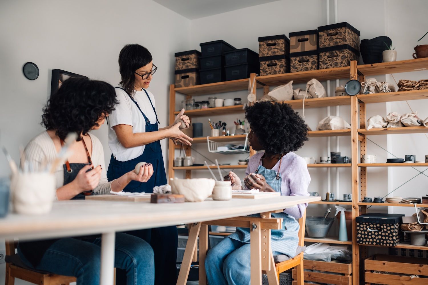 people working with pottery and clay