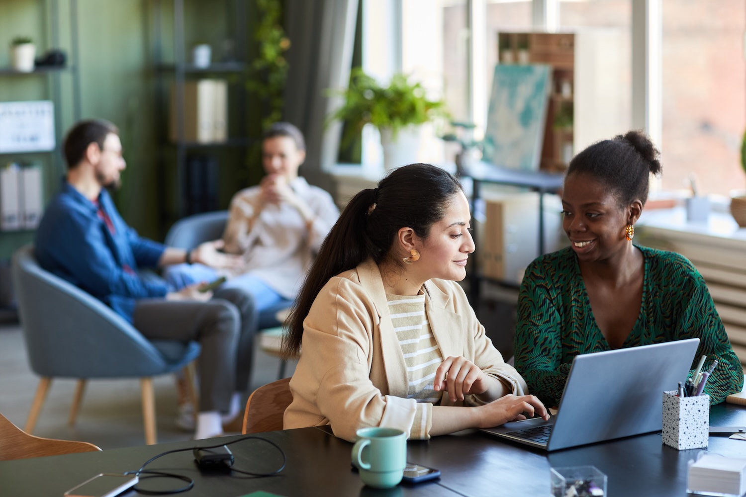 two young people in an office on a computer